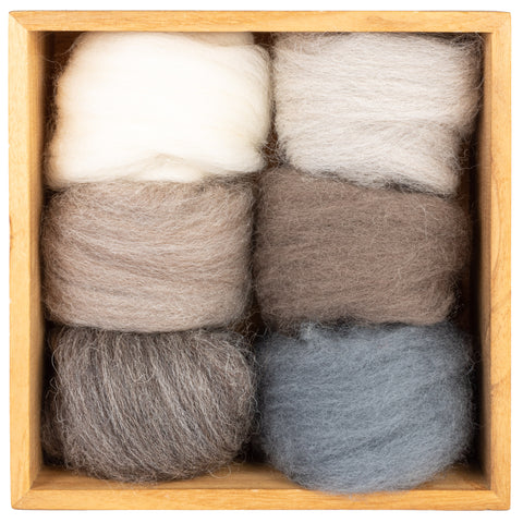 four skeins of wool in a wooden box